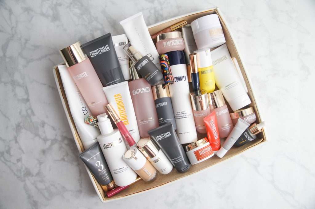 Pile of skincare products that may lead to bad skin