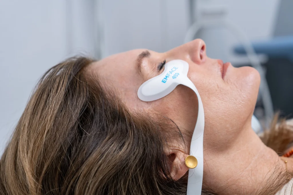 Patient undergoing non-invasive facial lifting treatment