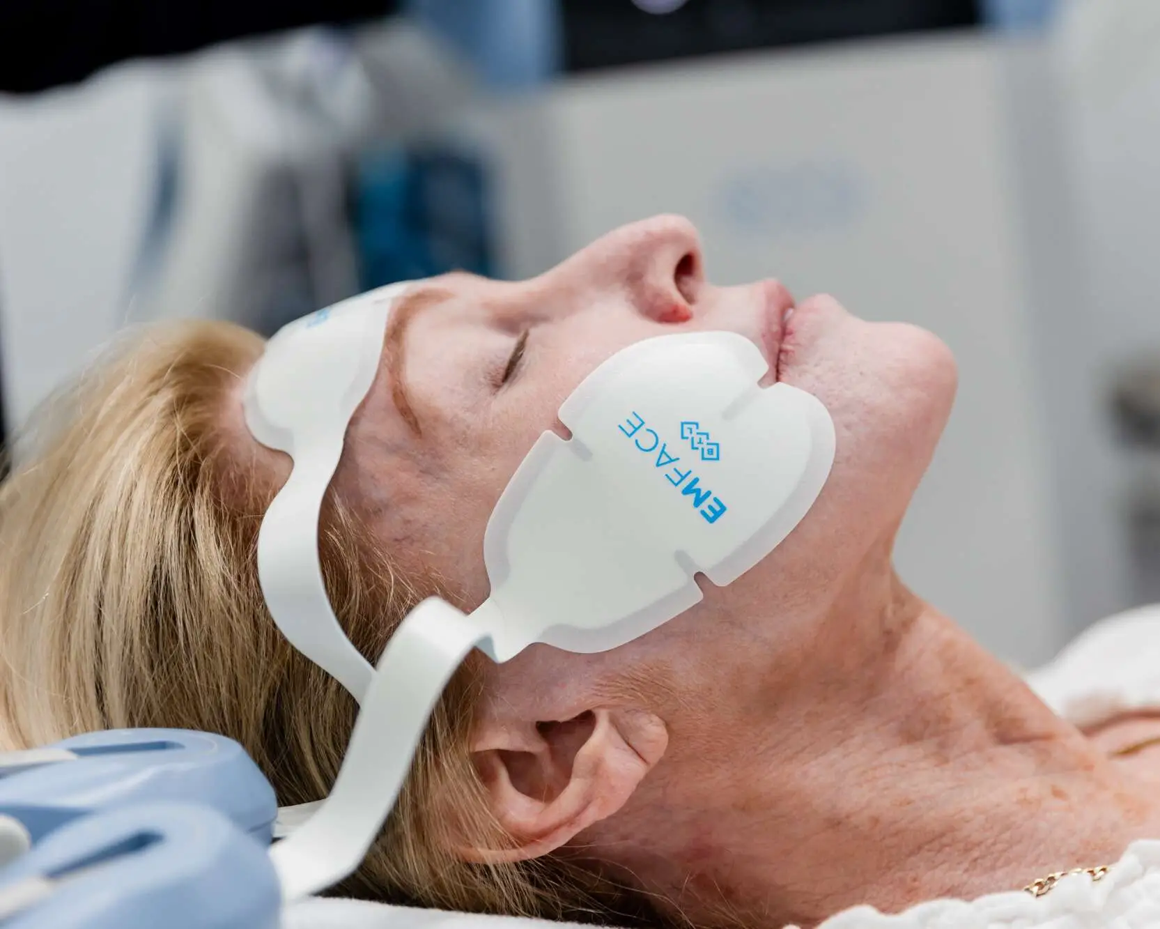 Muscle stimulating applicators positioned on the forehead and cheeks
