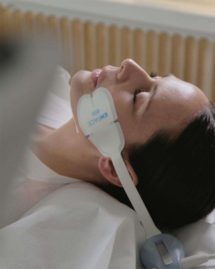 Patient receiving EMFACE needle free facial toning treatment at Allurant Medical Spa in San Diego