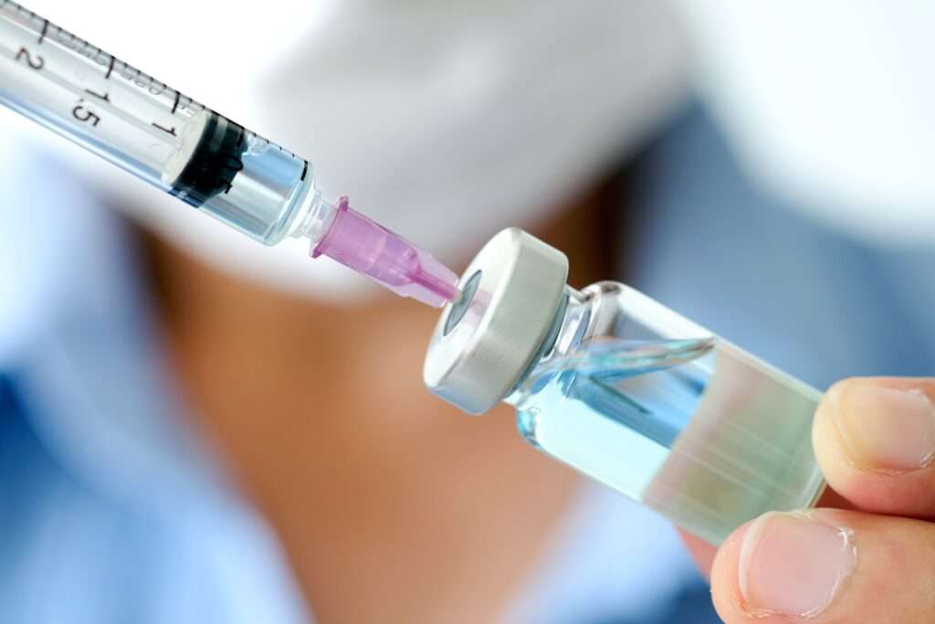 Healthcare provider preparing a tirzepatide injection during a physician-supervised medical weight loss consultation.