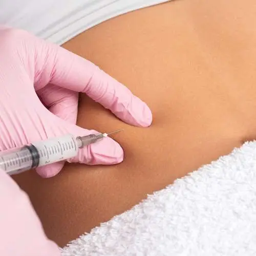 Healthcare provider administering a GLP-1 injection during a physician-supervised medical weight loss evaluation.
