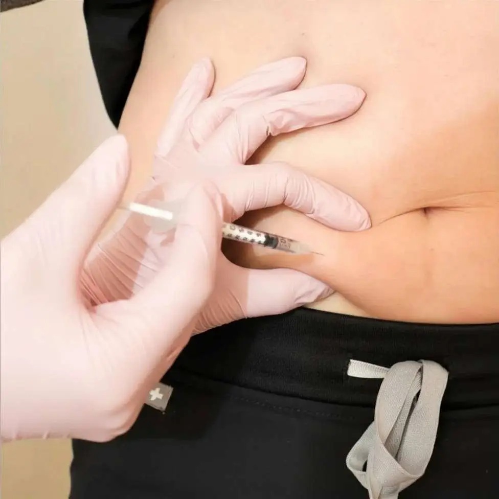 Healthcare provider administering semaglutide during a physician-supervised medical weight loss consultation.