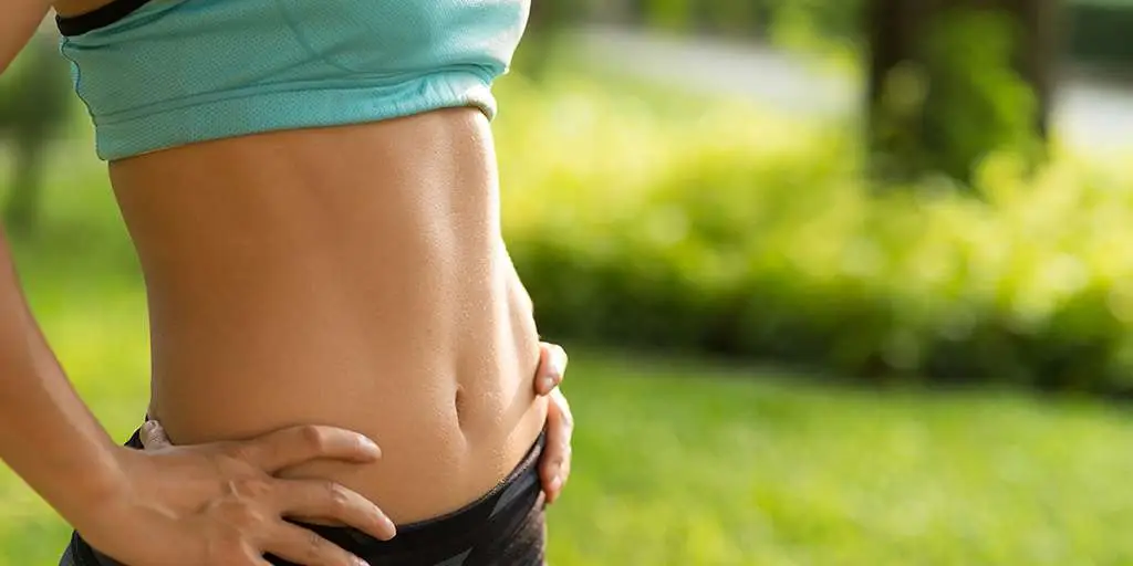 Woman showing abdomen treatment results non surgical body contouring San Diego Allurant Medical Spa