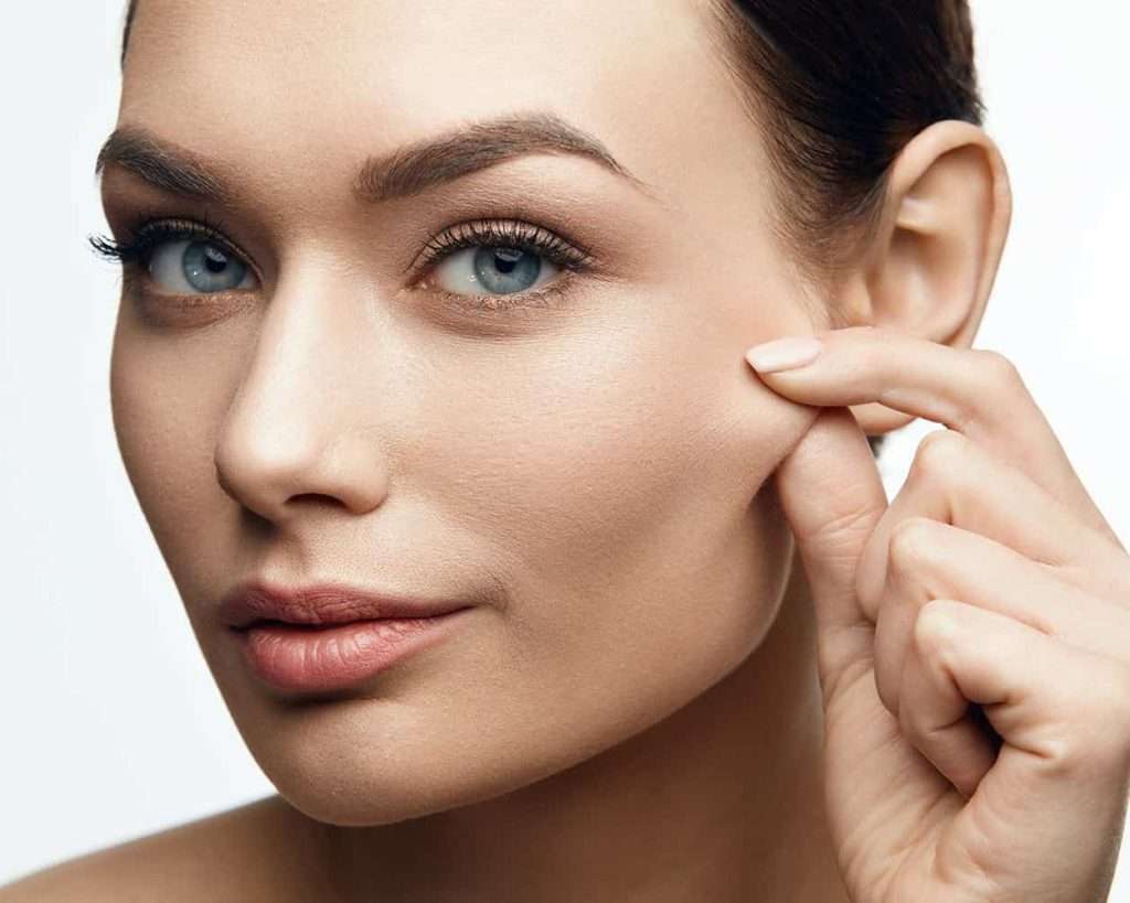 Woman with visibly lifted brows and firm facial skin after completing a series of EMFACE collagen stimulation treatments at a Carmel Valley medical spa