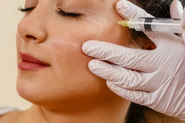 Medical injector reviewing dermal filler treatment plan with patient at Allurant Medical Spa