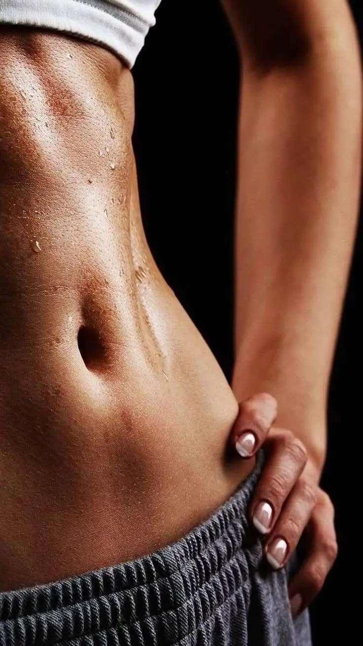 Woman showing toned defined abdomen after body contouring treatments Allurant Medical Spa San Diego
