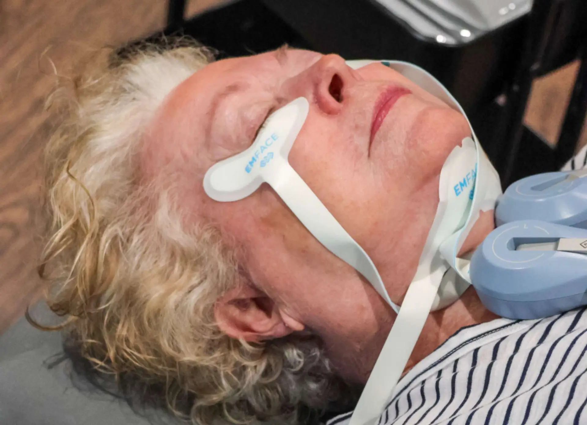 Woman over 60 receiving EMFACE facial treatment at Allurant Medical Spa in Carmel Valley San Diego