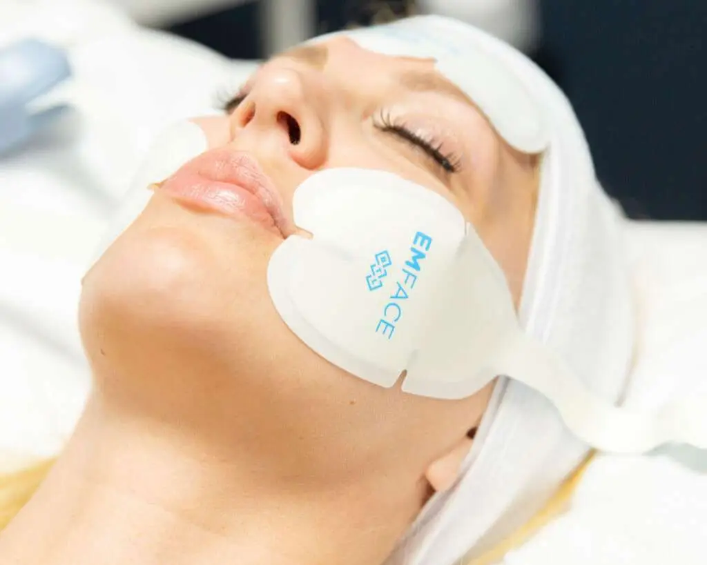 Woman with lifted, smooth facial skin after a non-surgical EMFACE treatment series at a medical spa in San Diego
