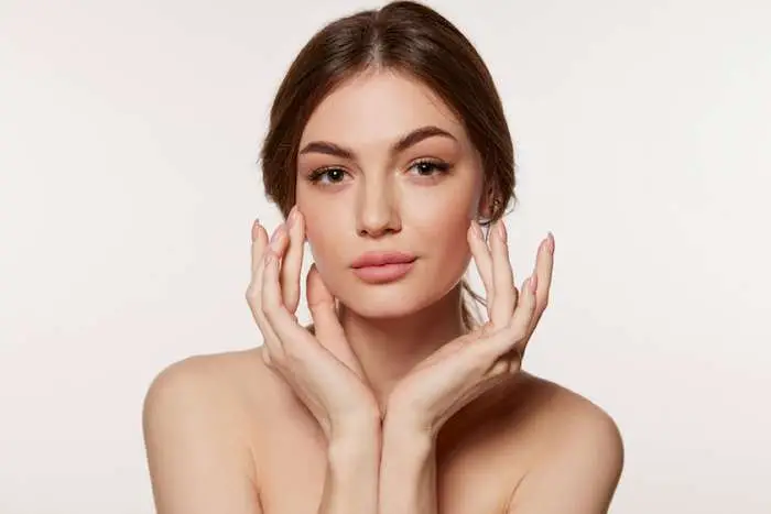 Woman smiling with smooth healthy skin after EMFACE vs Sculptra collagen treatment in San Diego
