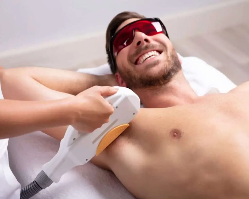Laser hair removal device treating a man's chest at Allurant Medical Spa