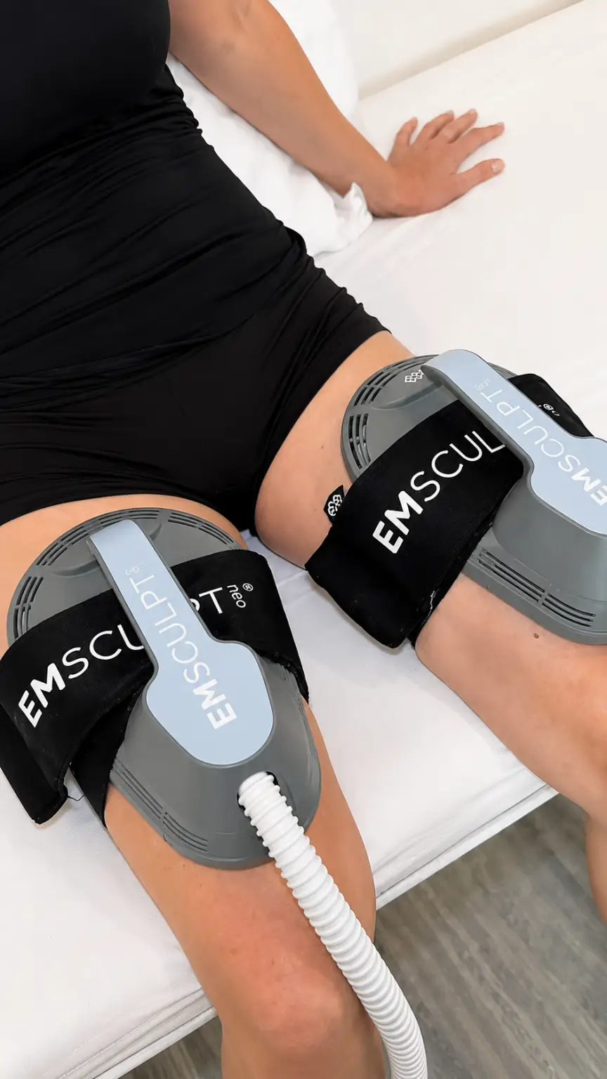Patient comfortably receiving EMSCULPT NEO treatment to strengthen calf muscles and improve leg definition at Allurant Medical Spa.