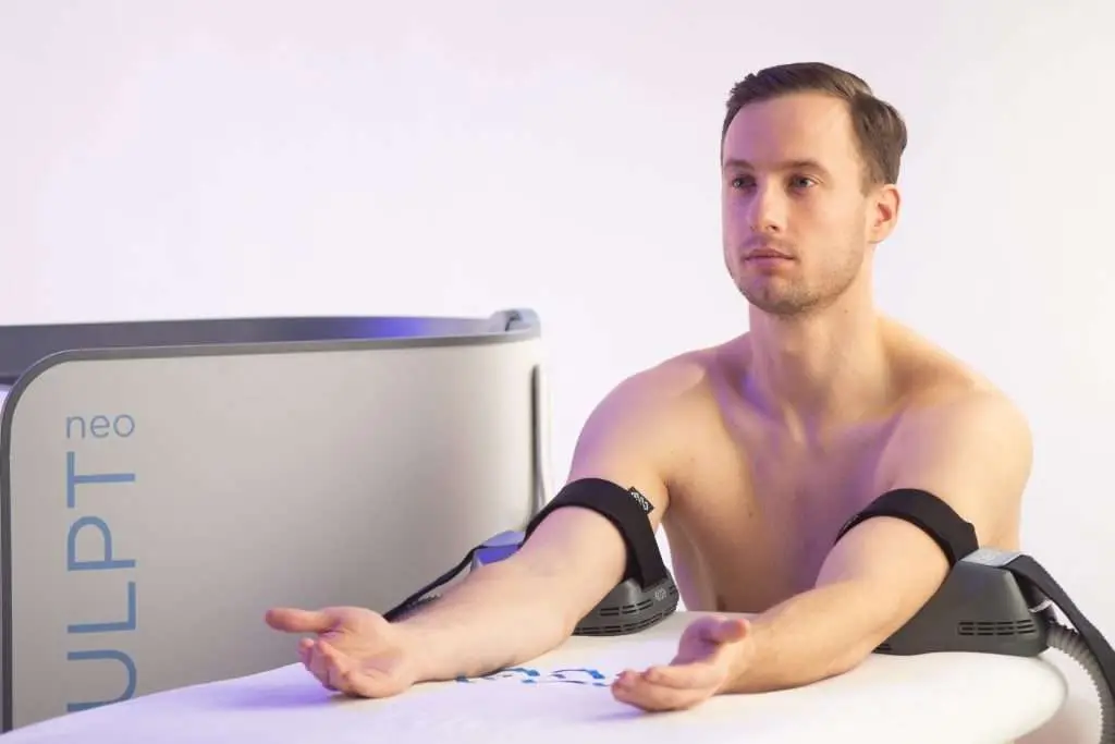 Provider consulting with male patient about arm contouring for men at Allurant Medical Spa
