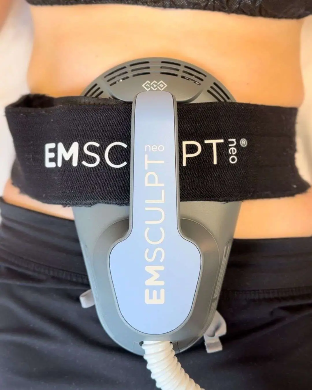 Emsculpt Neo device delivering muscle building and fat reduction treatment