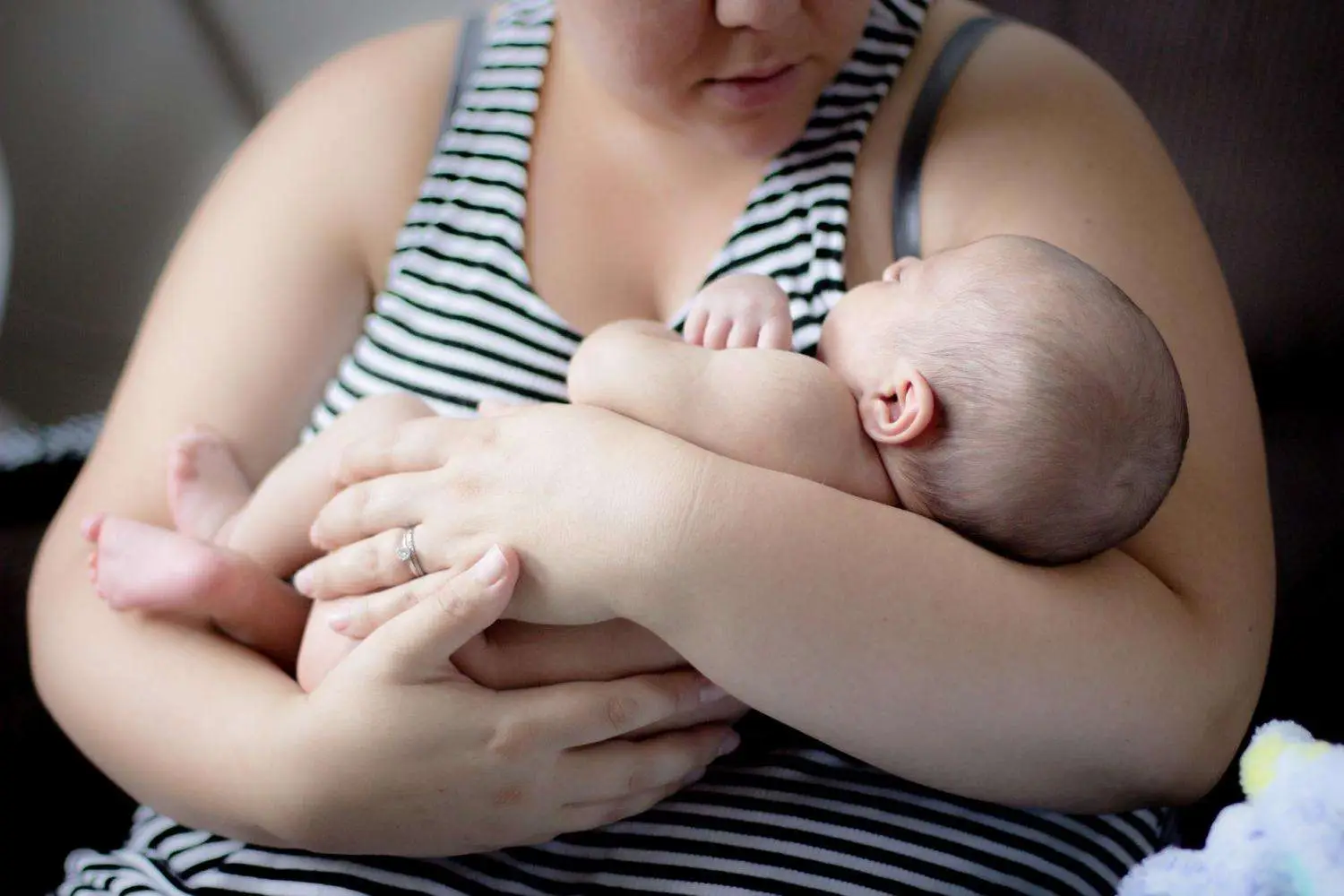 New mother reviewing postpartum arm skin changes with provider at Allurant Medical Spa
