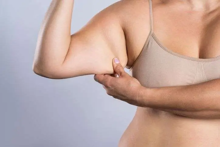 Provider consulting with new mother about postpartum arm skin changes at Allurant Medical Spa
