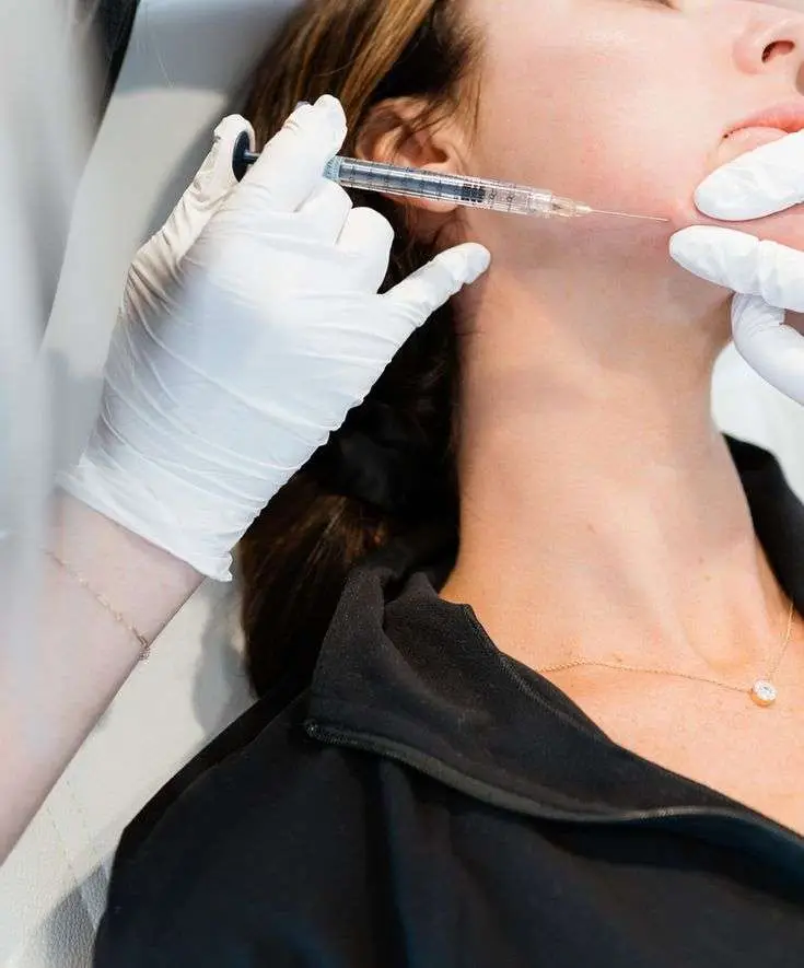 Provider performing a jawline injectable treatment to improve facial support and lower face definition